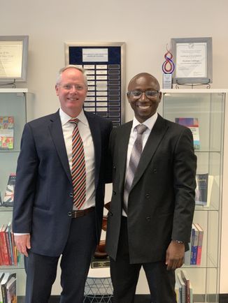 New York State Teacher of the Year Alhassan Susso posing with Dean Michael Middleton