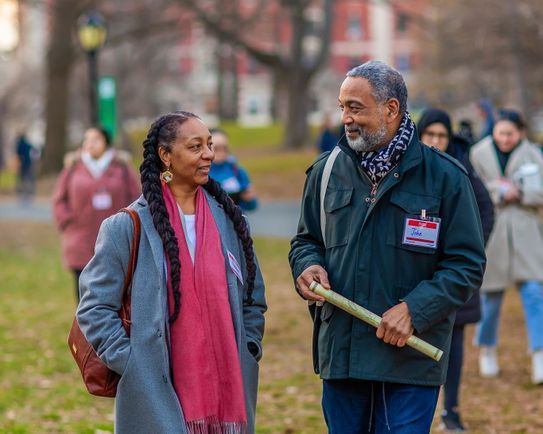 Dr. Nadine Bryce, left, and John Reddick, right, walk and talk in Central Park.