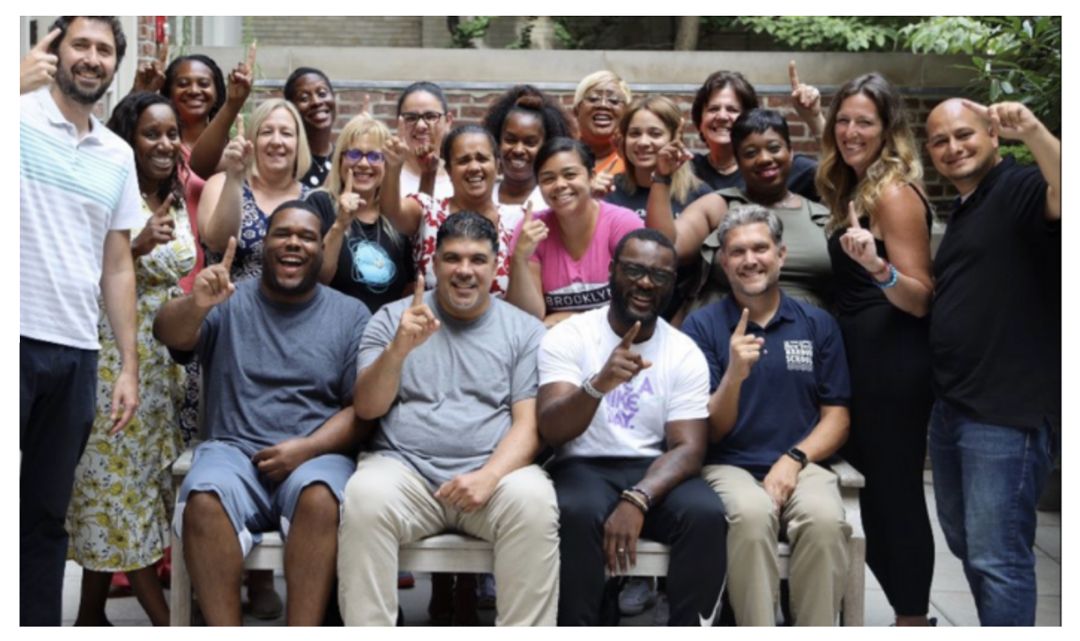 The 2019 to 20 Gray Fellows "Wolfpack" Cohort gather in a courtyard.