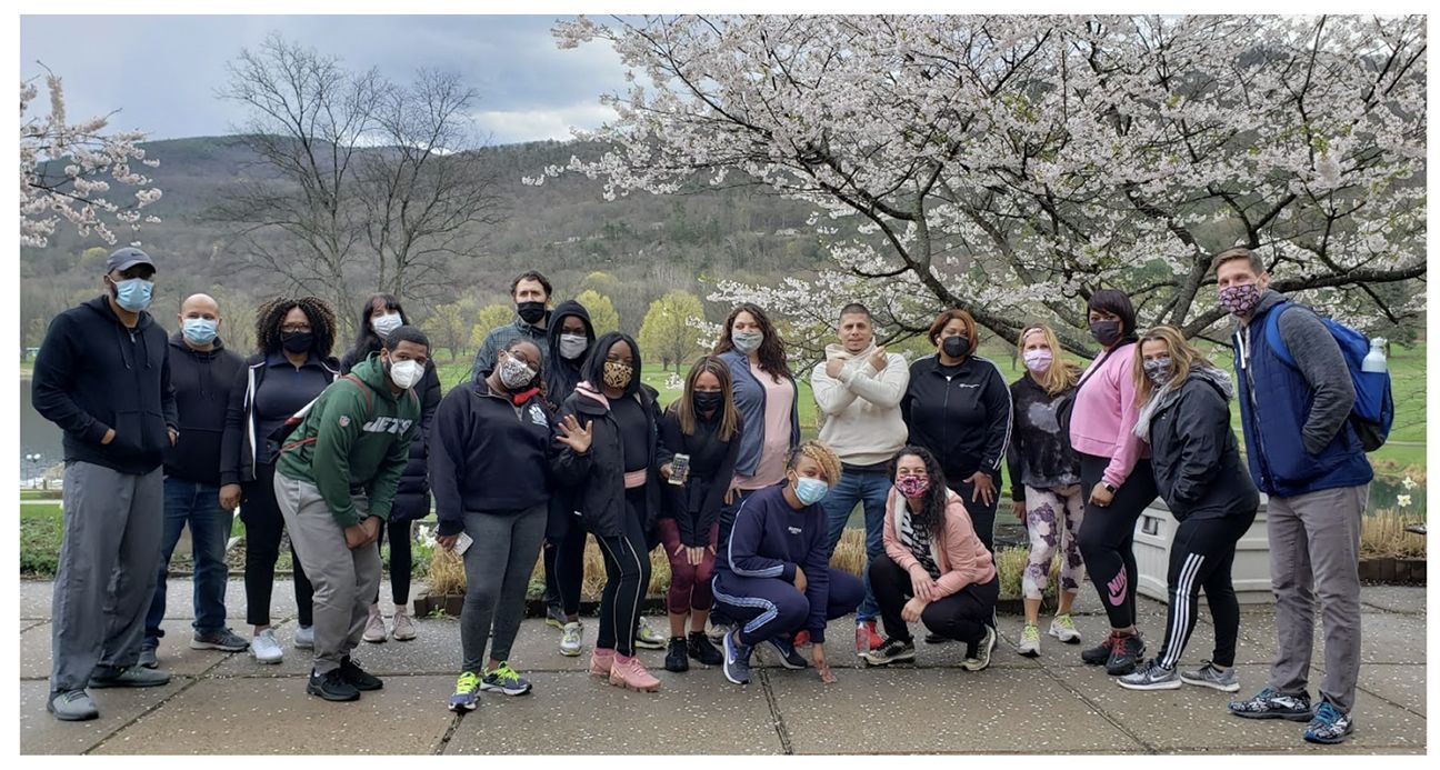 The 2020 to 2021 Gray Fellows "Cardinals" cohort gathers in front of a blossoming cherry tree.